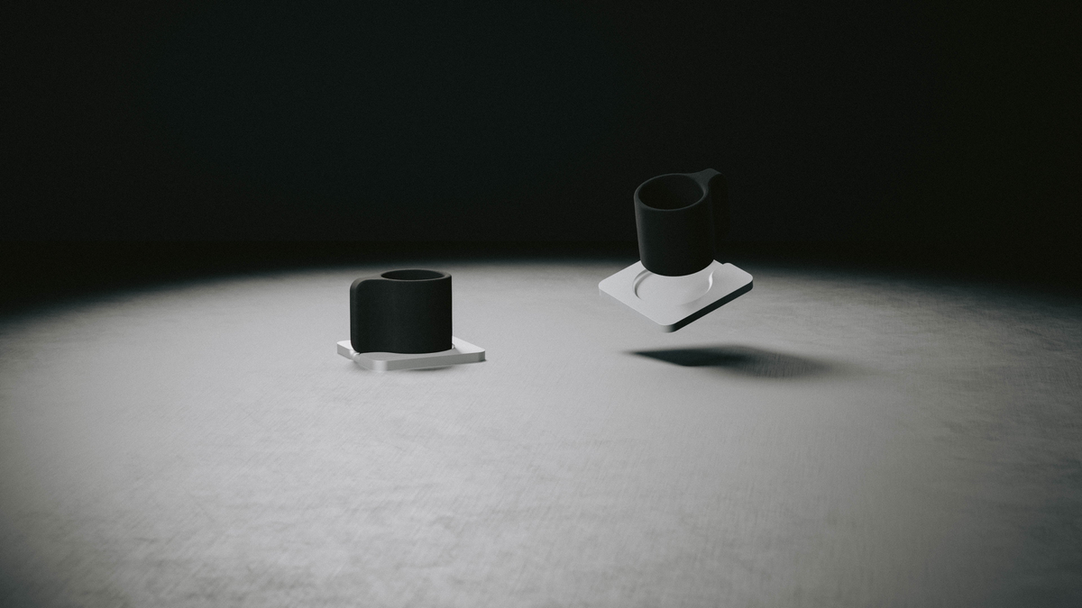 Espresso Cups in black stoneware on aluminum saucers, under a single spotlight