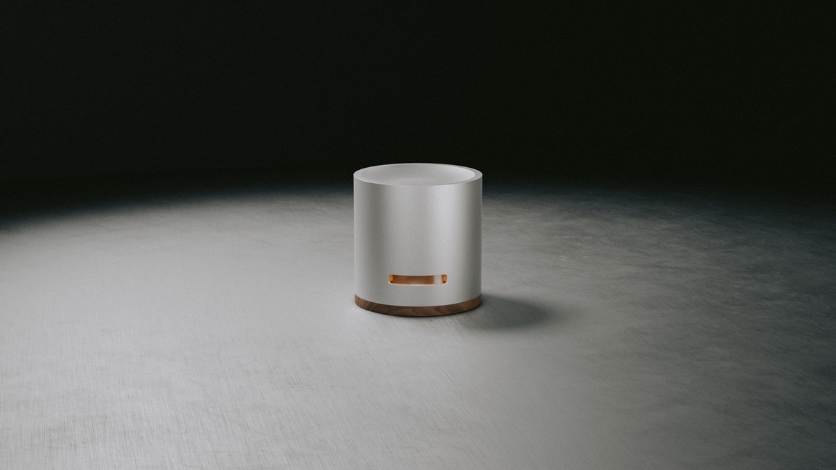 Oil Diffuser in aluminum with a walnut base, under a spotlight